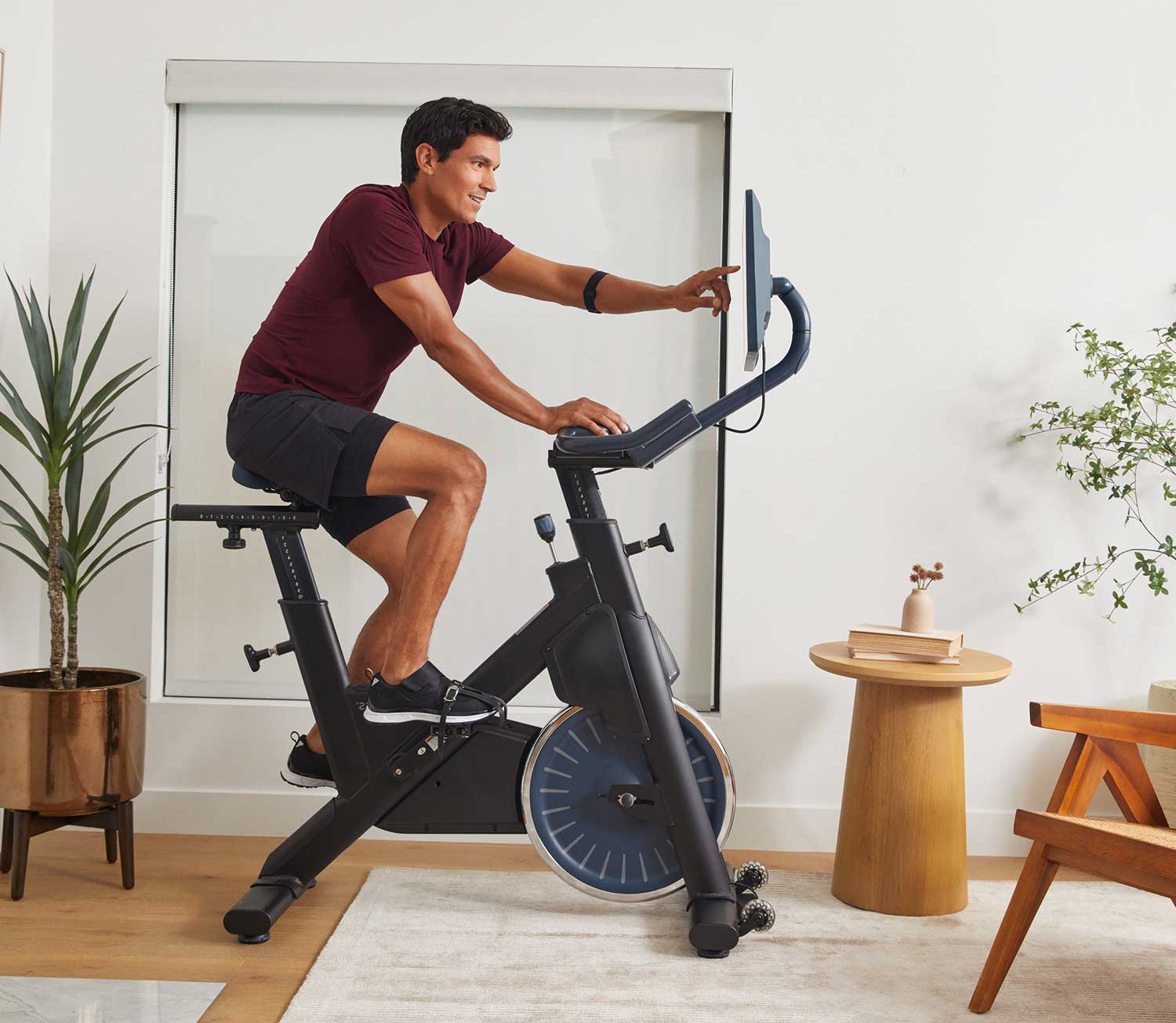 BODi+MYXFitness customer selecting her workout on her new MYX excercise bike
